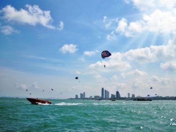 Low angle view of person parasailing at sea