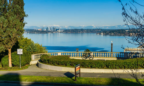 A view of the skyline of bellevue, washington with a fence in the foreground.