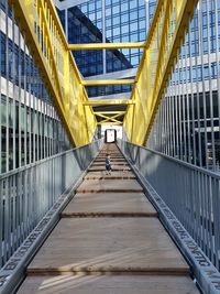 Boy walking on bridge in city