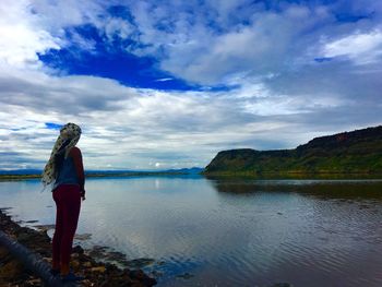 Scenic view of lake against cloudy sky