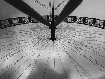 Low angle view of suspension bridge against sky