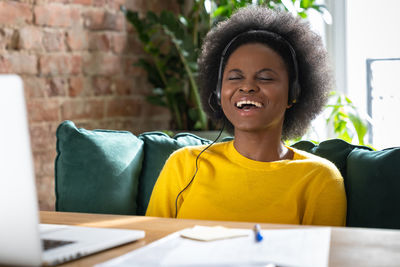 Portrait of smiling young woman sitting on table