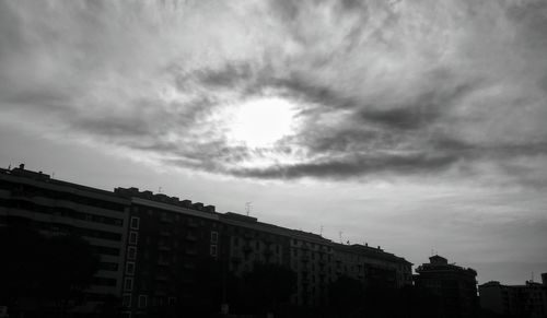 Low angle view of buildings in town against sky