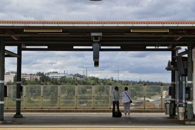 People standing on railroad platform 