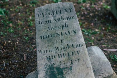 Close-up of text on stone at cemetery