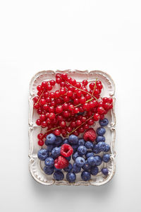 Directly above shot of strawberries in plate against white background