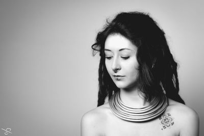 Portrait of beautiful young woman against white background