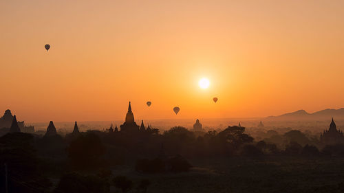 Silhouette of hot air balloon against sky during sunset