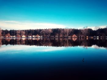 Scenic view of lake against clear blue sky