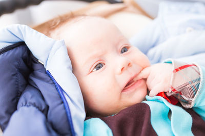 Portrait of cute baby lying on bed