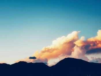 Scenic view of silhouette mountains against sky during sunset