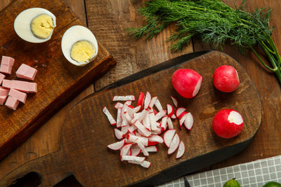 Vegetables and a knife on wooden planks on the table. horizontal photo