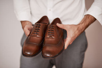 Midsection of man wearing shoes