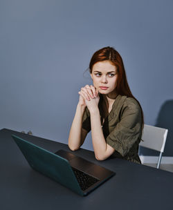 Young woman using laptop on table