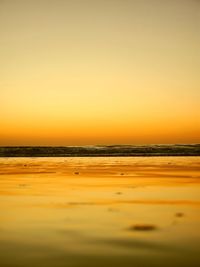 Scenic view of sea against clear sky during sunset