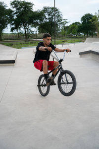 Full length of woman riding bicycle