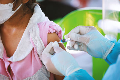 Midsection of doctor examining patient in hospital