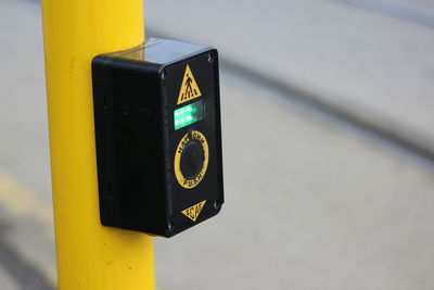 Cropped image of traffic light button on street