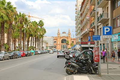 Cars on street against buildings in city