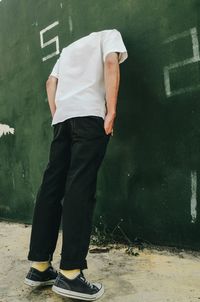 Rear view of man standing on wall
