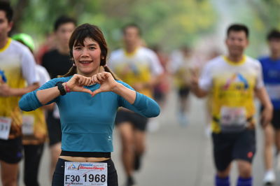 Portrait of a smiling young woman running outdoors