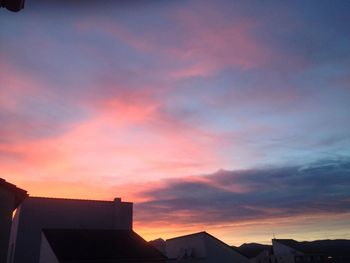 High section of building against sky at sunset