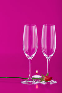 Close-up of wine glass against pink background