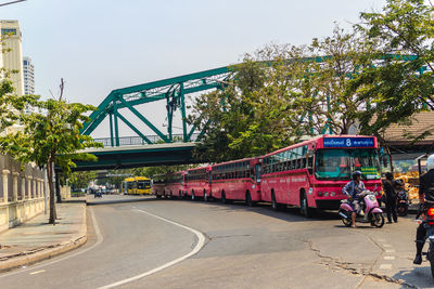 People on road in city against sky