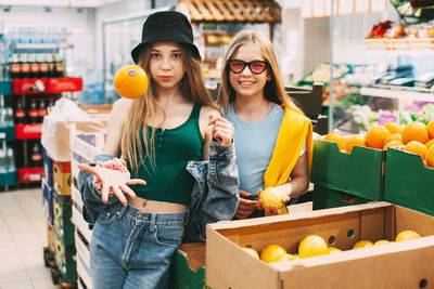 Young woman standing by food at market