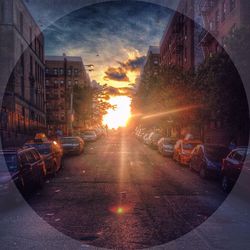 Cars parked on road at sunset