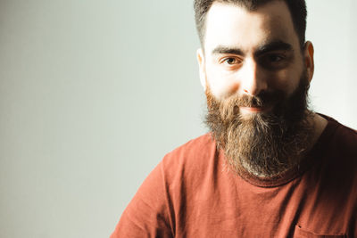 Portrait of young man against standing against gray background