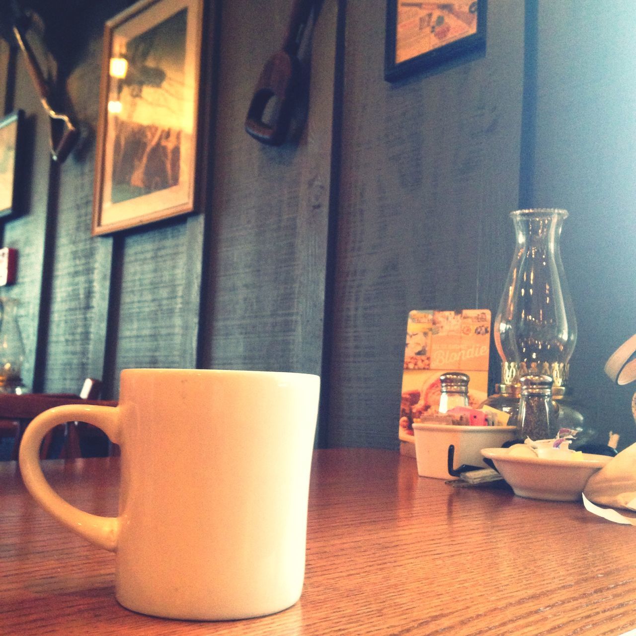 indoors, table, still life, food and drink, drink, chair, absence, no people, restaurant, close-up, home interior, empty, refreshment, focus on foreground, wood - material, coffee cup, place setting, technology, day, bottle