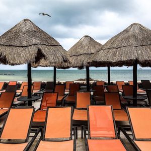 Deck chairs and thatched roof at beach