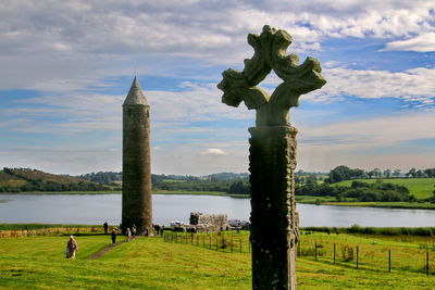 Low angle view of celtic cross against sky at devenish island