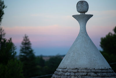 Close-up of cross against sky during sunset