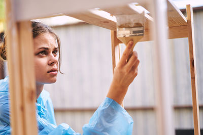 Portrait of young woman standing in workshop