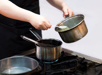 Midsection of man preparing food in kitchen