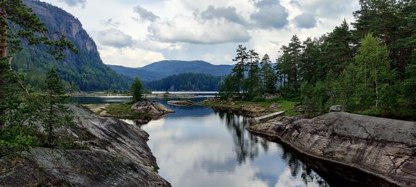 Panoramic view of lake amidst mountains against sky
