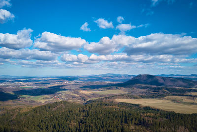 Drone flight over mountains covered with forest and valleys