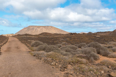 View of desert against cloudy sky