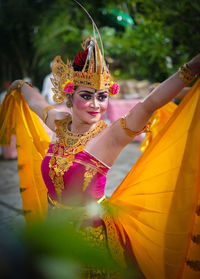 Smiling woman dancing during traditional festival