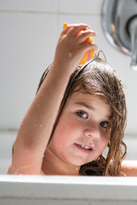 Close-up portrait of girl with soap in bathroom