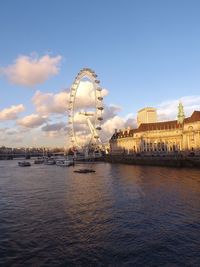 Ferris wheel in city against sky