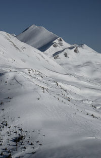 Snow covered peak in the swiss alps on a sunny winter day.