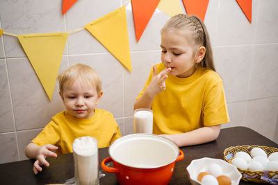 Kids prepare dough for holiday cupcake holiday easter, eggs on the table