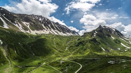 Scenic view of mountains against cloudy sky