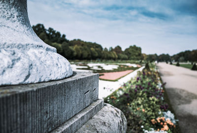 Close-up of retaining wall by footpath against sky