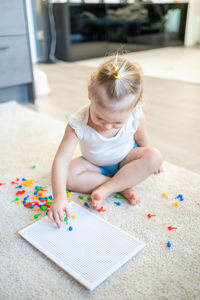 High angle view of cute girl playing with toy at home