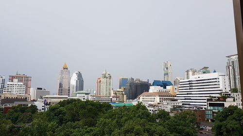 Buildings in city against clear sky