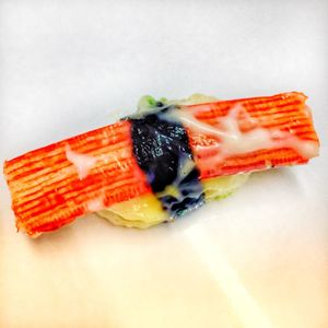 Close-up of sushi in plate against white background